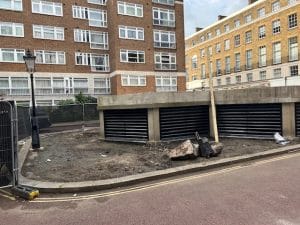 A slate and steel building stands proudly near the road, blending modern elegance with industrial strength.